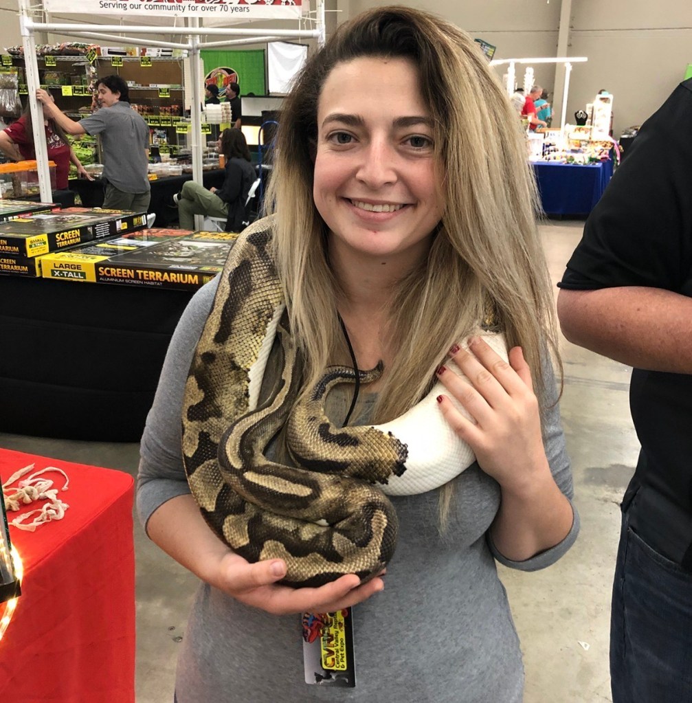 Micah enjoys all types of reptiles. Here she is holding a snake at a reptile show. 